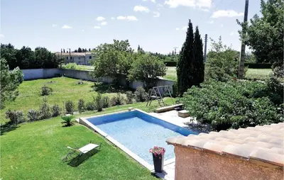 a backyard with a swimming pool in a yard at Nice Home In Eyguieres With Wifi in Eyguières