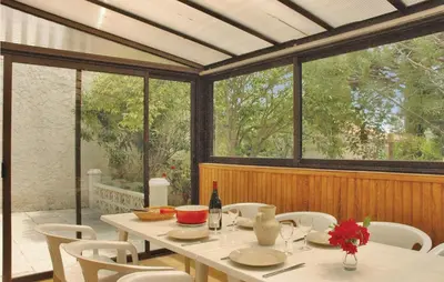 a dining room with a white table and white chairs at Nice Home In Saint Cannat With Wifi in Saint-Cannat