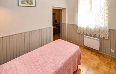 a bedroom with a bed with a pink blanket at Nice Home In Saint Cannat With Wifi in Saint-Cannat