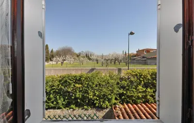 a window with a view of a park with trees at Nice Home In Saint Cannat With Wifi in Saint-Cannat