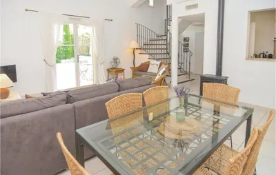 a living room with a couch and a glass table at Amazing Home In Saint Remy De Provence in Saint-Rémy-de-Provence