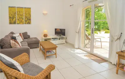 a living room with a couch and a table at Amazing Home In Saint Remy De Provence in Saint-Rémy-de-Provence