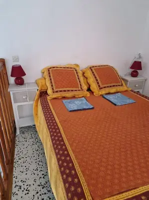 a bedroom with a bed with two pillows on it at Gîte Le Val des Fées classés deux étoiles in Roussillon