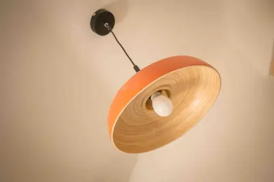 a wooden light hanging on a wall at Petit Cocon avec Vue Dernier Etage - Mazarin 1833 in Aix-en-Provence