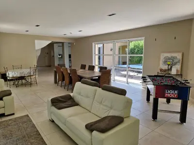 a living room with a couch and a ping pong table at Mas Libertino - Villa avec piscine & jacuzzi in Pernes-les-Fontaines