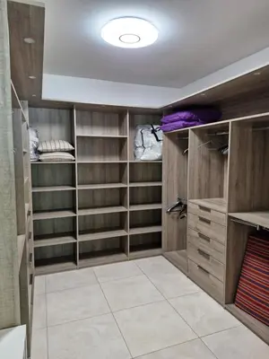 a walk in closet with wooden cabinets and shelves at Mas Libertino - Villa avec piscine & jacuzzi in Pernes-les-Fontaines