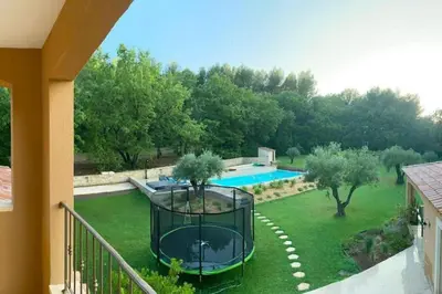 a view of a yard with a swimming pool at Mas Libertino - Villa avec piscine & jacuzzi in Pernes-les-Fontaines
