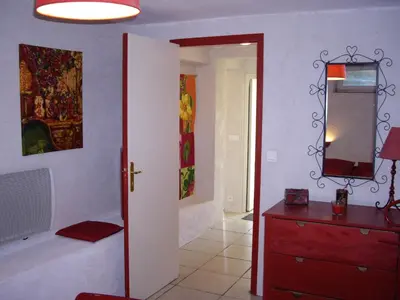 a room with a red dresser and a mirror at La Bastide de Mauragne - Gîte Les Pivoines in Apt