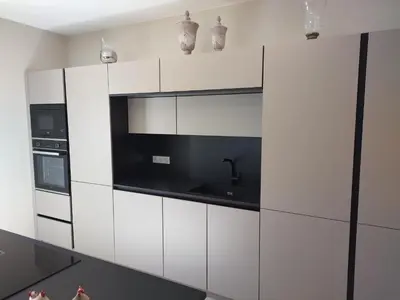 a kitchen with white cabinets and a black microwave at Le mas de Roussillon chambre d'hôtes in Roussillon
