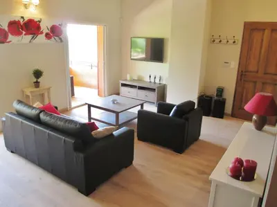 a living room with two couches and a table at appartement T3 dans propriété de 5000m2 avec piscine in Venelles