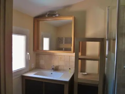 a bathroom with a sink and a mirror at appartement T3 dans propriété de 5000m2 avec piscine in Venelles
