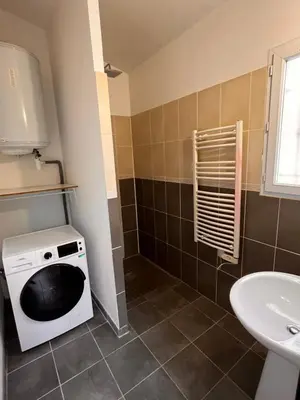 a small bathroom with a washer and dryer in it at LES VIEUX CABASSOLS VENELLES in Venelles