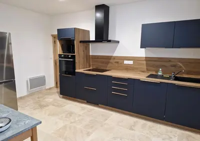 a large kitchen with blue cabinets and a sink at Appartement de caractère - CARPENTRAS - Rendez-vous en Provence in Carpentras
