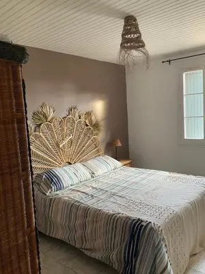 a bedroom with a large bed with a large headboard at Lou Jasset in Cabrières-dʼAigues