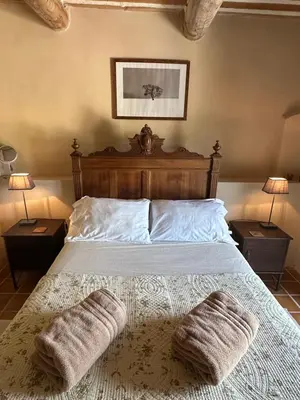 a bedroom with a bed with two towels on it at La Terrasse - Entire townhouse in hilltop village in Saint-Martin-de-Castillon