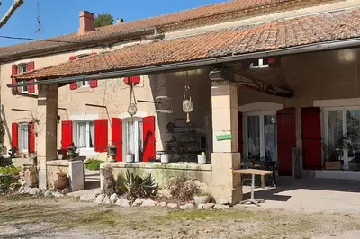 a long wooden table and chairs outside of a building at Chambres d'Hôtes et Suite, Domaine Les Peupliers, Lagnes in Lagnes