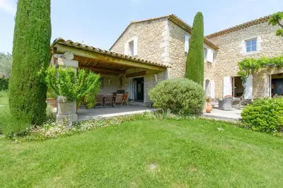 an exterior view of a house with a yard at Mas des Papillons Gordes in Gordes