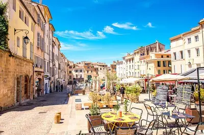a city street with tables and chairs and buildings at Appartement de Charme in Aix-en-Provence