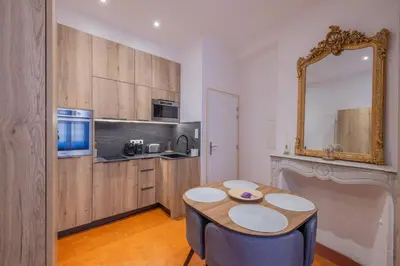 a kitchen with a table and a mirror at Appartement de Charme in Aix-en-Provence