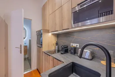 a kitchen with a sink and a microwave at Appartement de Charme in Aix-en-Provence
