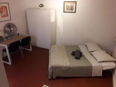 a small bedroom with a bed and a desk at Studio, Aix centre historique in Aix-en-Provence