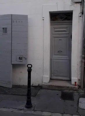 a pole in front of a building with a door at Studio, Aix centre historique in Aix-en-Provence