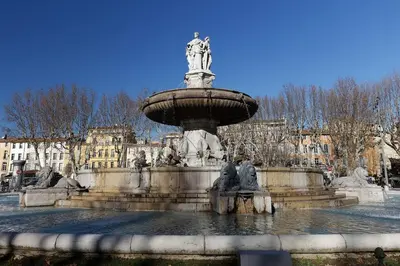 a fountain in a park in front of a building at Studio, Aix centre historique in Aix-en-Provence