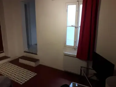 a small room with a window and a mirror at Studio, Aix centre historique in Aix-en-Provence