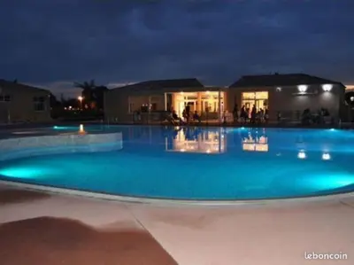 a large swimming pool at night with blue lighting at Maison de vacances Aubignan in Aubignan