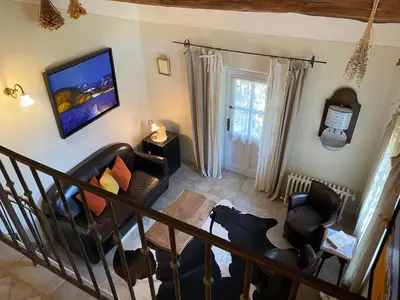 a living room with a couch and a table at Mas de la Beaume in Gordes