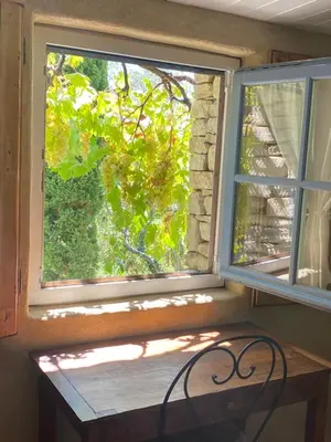 a window with a wooden bench in front of it at Mas de la Beaume in Gordes