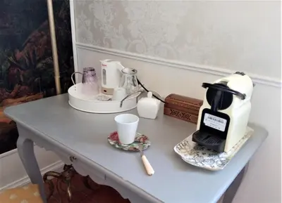 a table with a coffee maker and cups on it at Hote-Aix-Centre-garage-piscine in Aix-en-Provence
