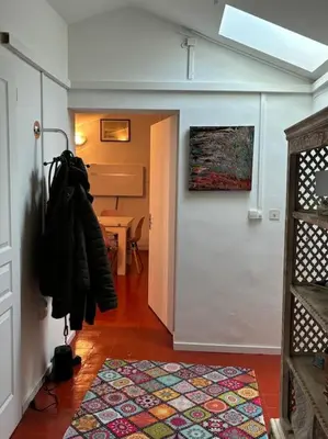 a hallway with a door and a room with a table at plein coeur de BANON in Banon