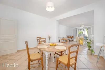 a kitchen and dining room with a table and chairs at Maison Alena Lourmarin Main Square in Lourmarin