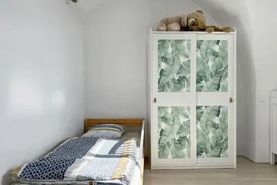 a bedroom with a bed and a white cabinet at Les Terrasses du Château I Electio in Lauris