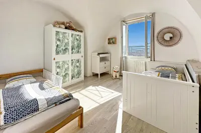 a bedroom with a bed and a window at Les Terrasses du Château I Electio in Lauris