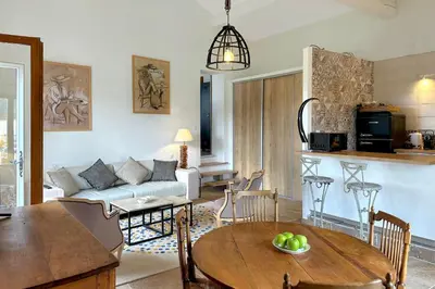 a living room with a couch and a table at Appartement I Bastide La Gravière I Electio in Lourmarin
