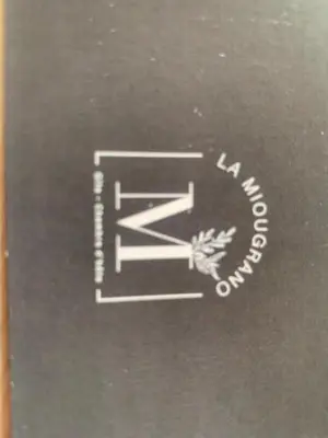 a black book with a white logo on it at La Miougrano in Plan-dʼOrgon