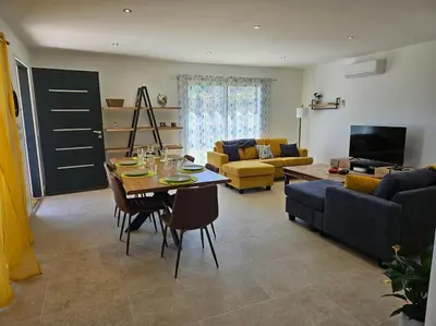a living room with a table and a couch at Maison en Provence avec piscine in Sainte-Tulle