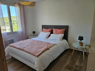 a bedroom with a large bed and a window at Maison en Provence avec piscine in Sainte-Tulle