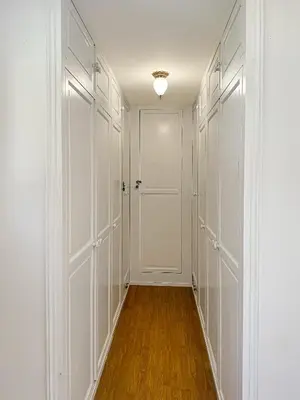 an empty hallway with white closets and a door at Villa Edelweiss in Lauris