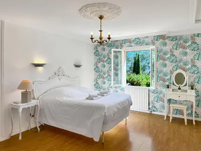 a bedroom with a white bed and a window at Villa Edelweiss in Lauris