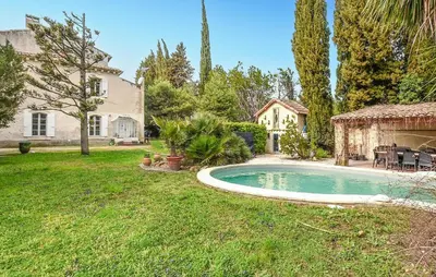 a backyard with a swimming pool and a house at Nice Home In Entraigues-Sur-La-Sorg in Entraigues-sur-la-Sorgue