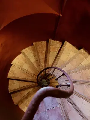 an overhead view of a wooden spiral staircase at Le Saint Hubert in Saint-Saturnin-les-Apt