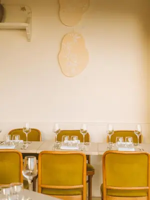 a dining room with a table and chairs and an apple sign at Le Saint Hubert in Saint-Saturnin-les-Apt