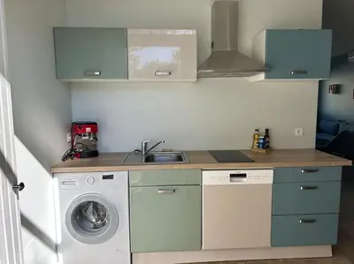 a kitchen with a sink and a washing machine at Détours en Provence - Lavande 3* in Châteaurenard