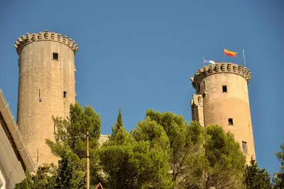 two towers on top of a building with trees at Détours en Provence - Lavande 3* in Châteaurenard