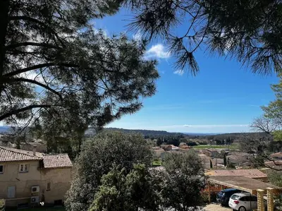 a view of a small village with cars parked in front at La villa Rosa in Bédoin