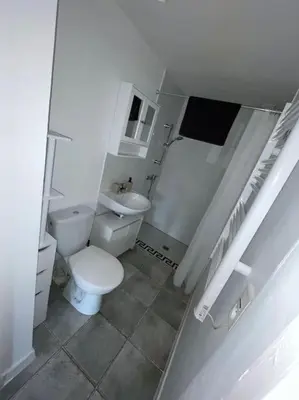 a white bathroom with a toilet and a sink at Appartement en campagne avec jardin et piscine in Grans