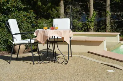 two chairs and a table with a glass of wine at Le Domaine d'Euphony in Monteux